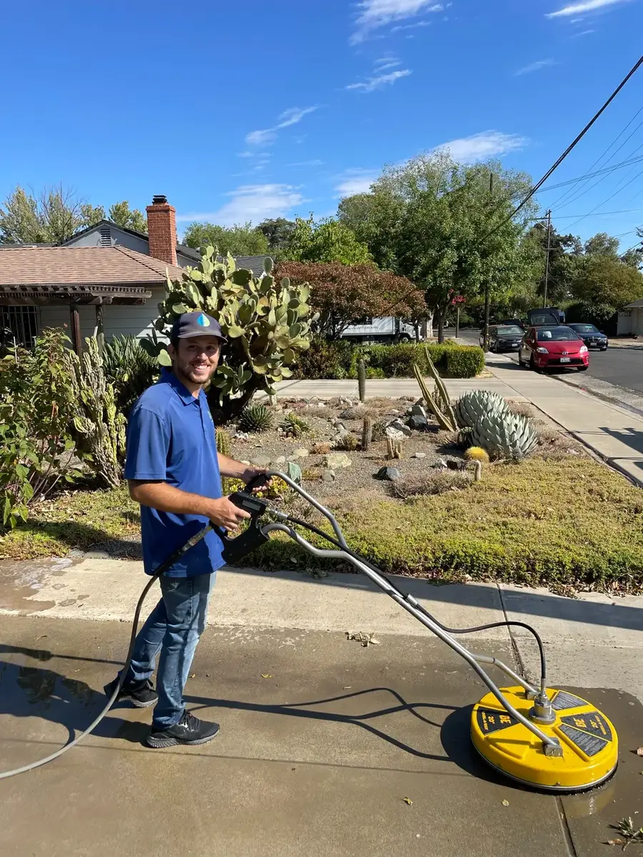 Primetime technician pressure washing a residential driveway